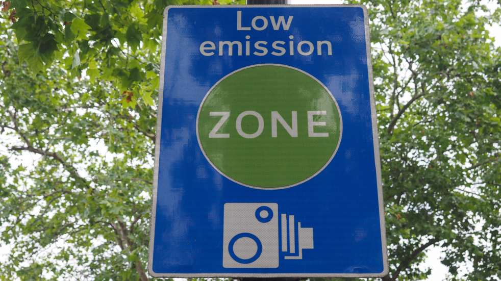 Should you buy a new or secondhand car low emission zone sign